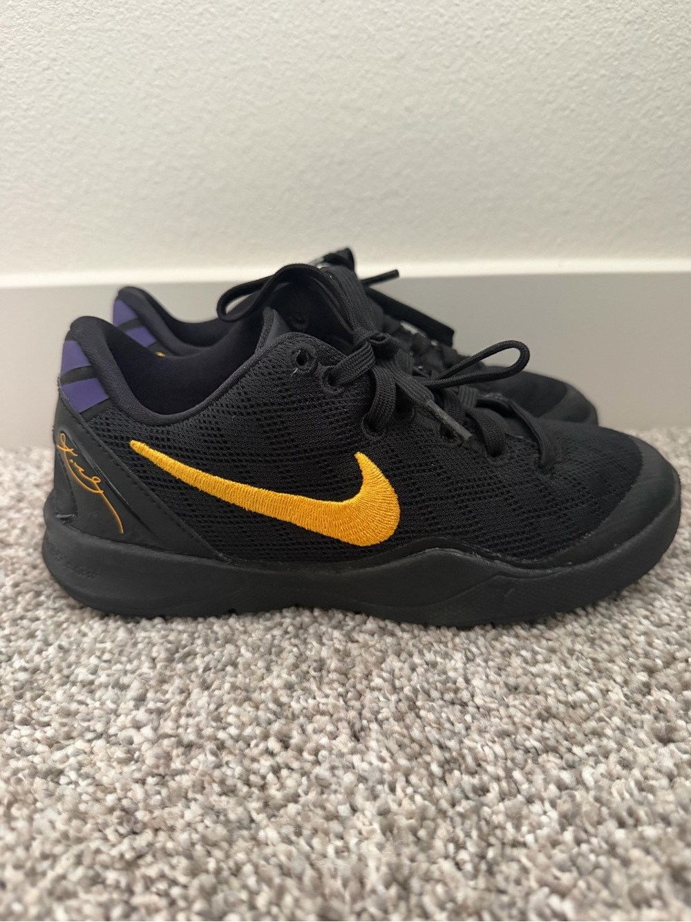 Nike Kids Black Sneakers with Gold Swoosh and Purple Accents